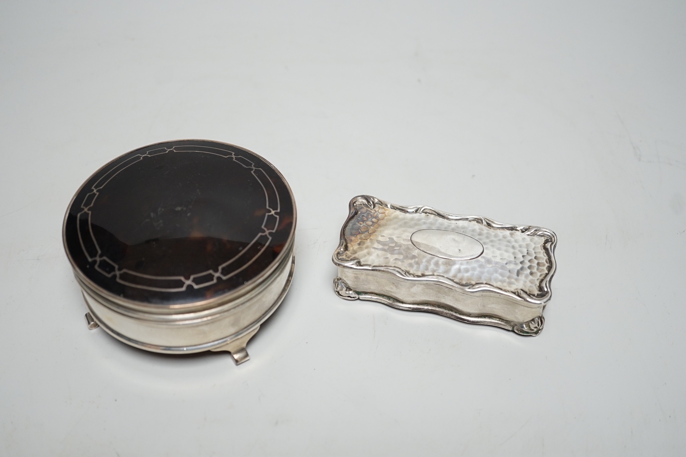 A George V silver and tortoiseshell mounted circular trinket box, Walker & Hall. Birmingham, 1918, 92mm and an earlier silver rectangular trinket box.
